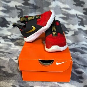 Nike Kids Red and Black Sneakers with Gold Accents